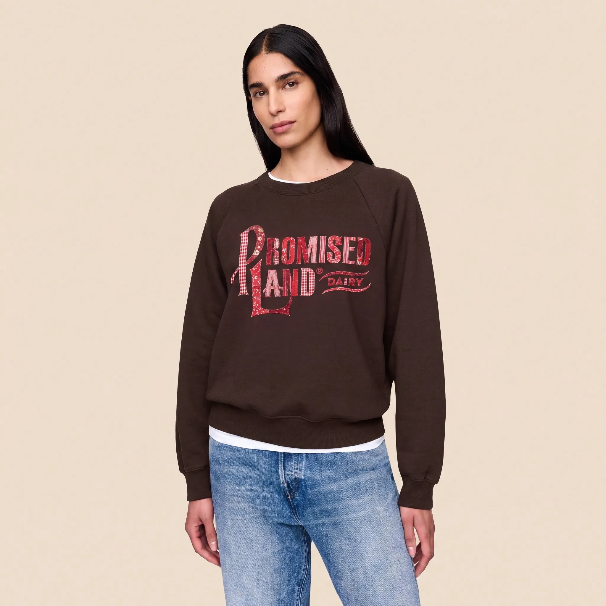 Brown sweatshirt with the Promised Land Dairy logo in red gingham and floral patchwork