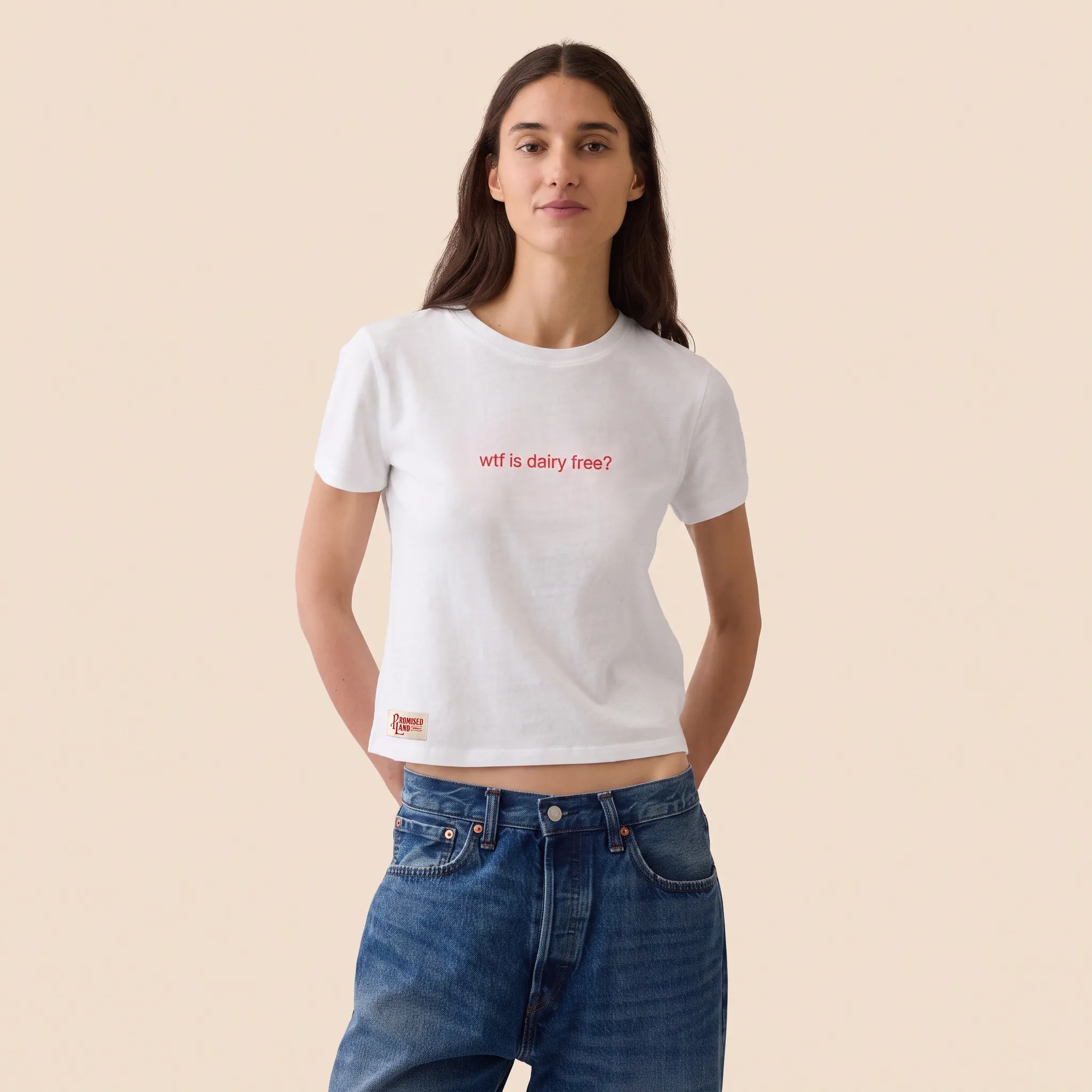 White t-shirt reading “wtf is dairy free?” with a small Promised Land Dairy label at the hem