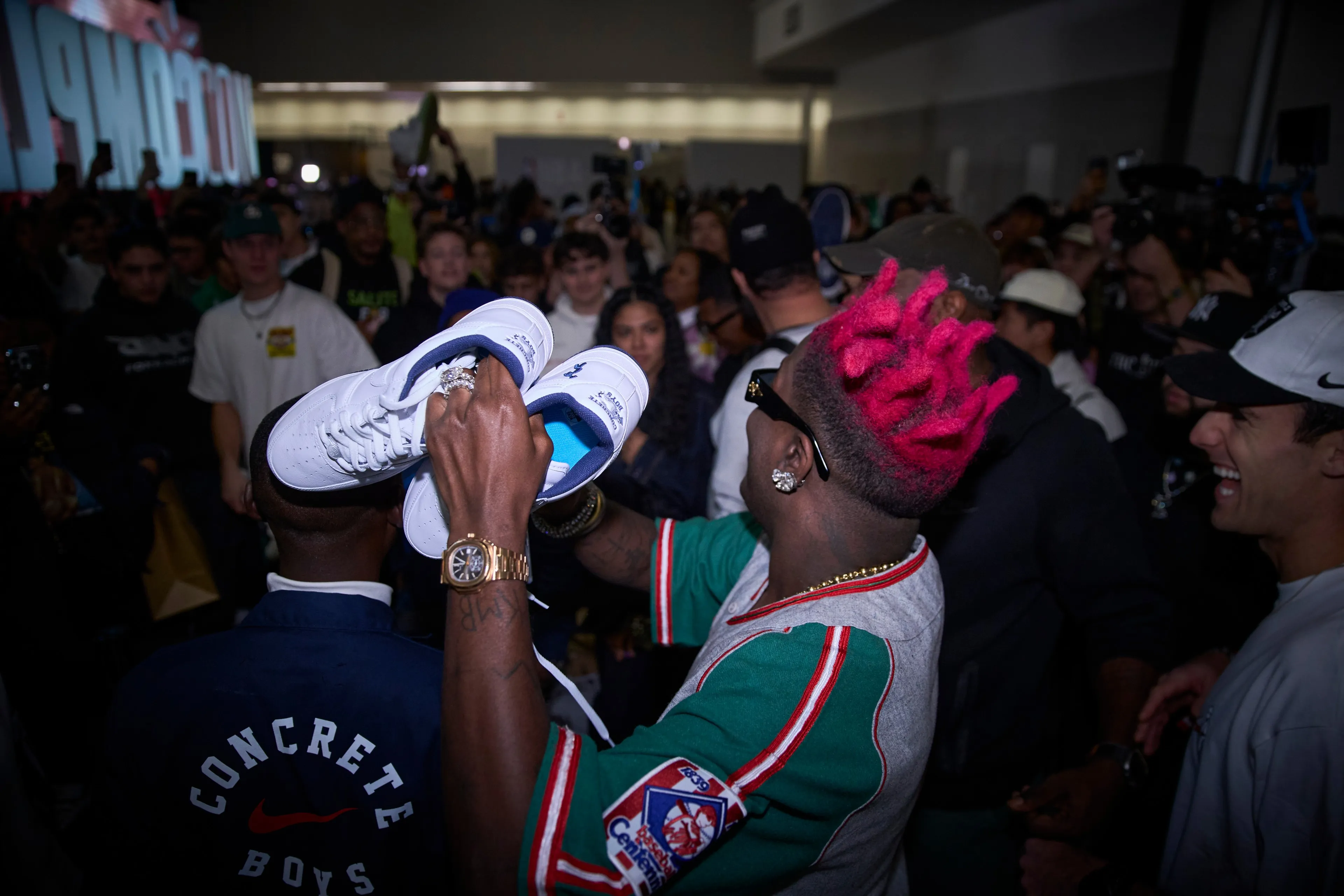 Lil Yachty holding a pair of US Force 1s over the crowd